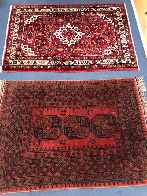 Two small red ground rugs 141 x 102cm. and 146 x 103cm